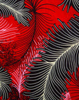 Close up display of red dress with black and white feather print, fabric.