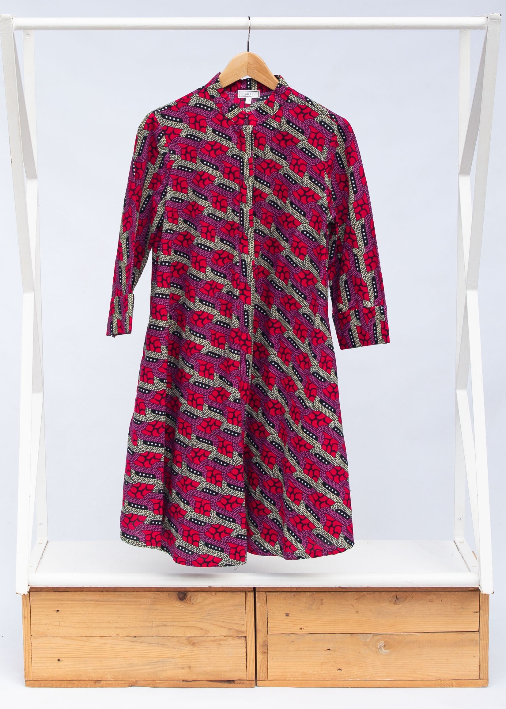 Display of red and pink geometric print dress.