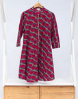 Display of red and pink geometric print dress.