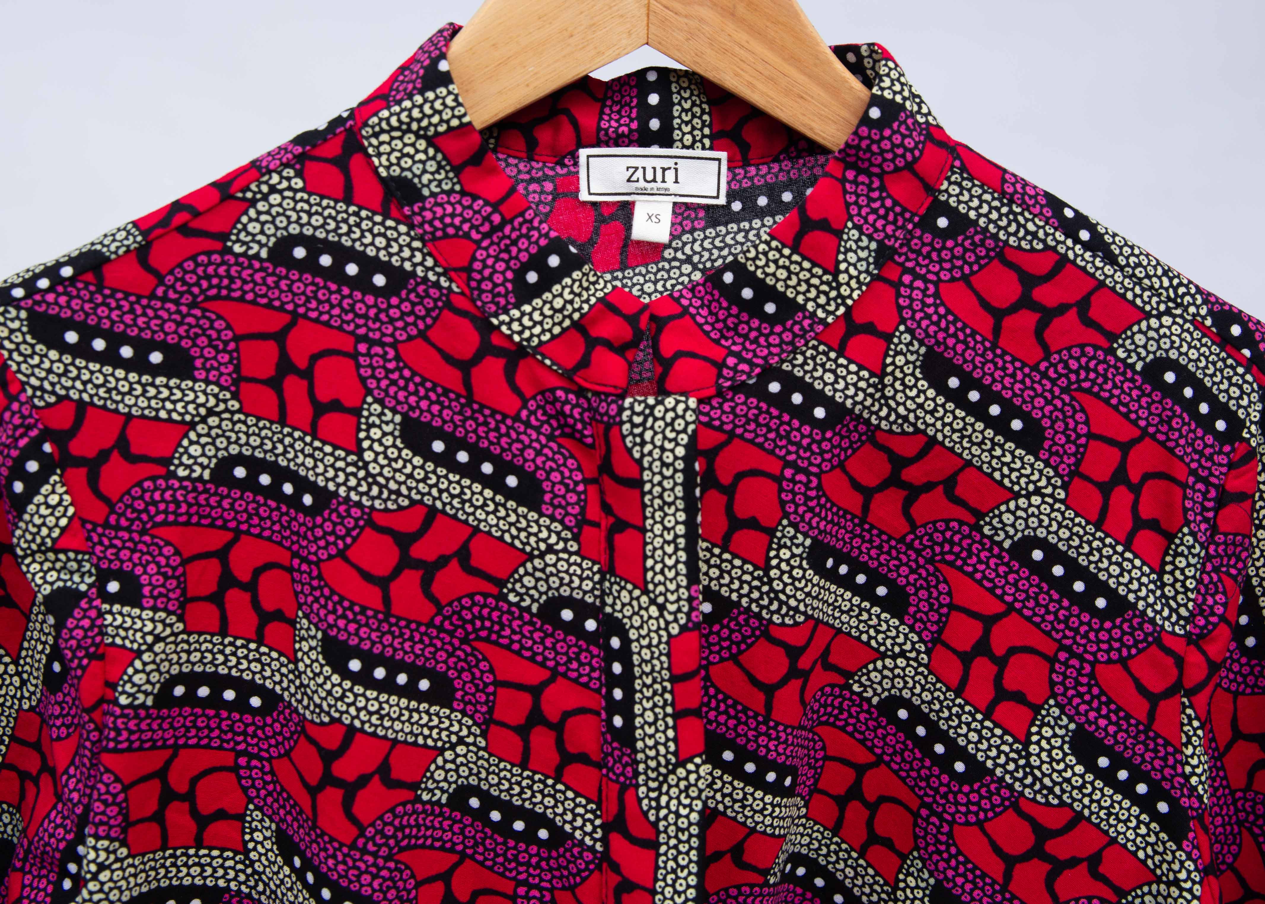 Display of red and pink geometric print dress.