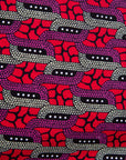 Close up display of red and pink geometric print dress, fabric.