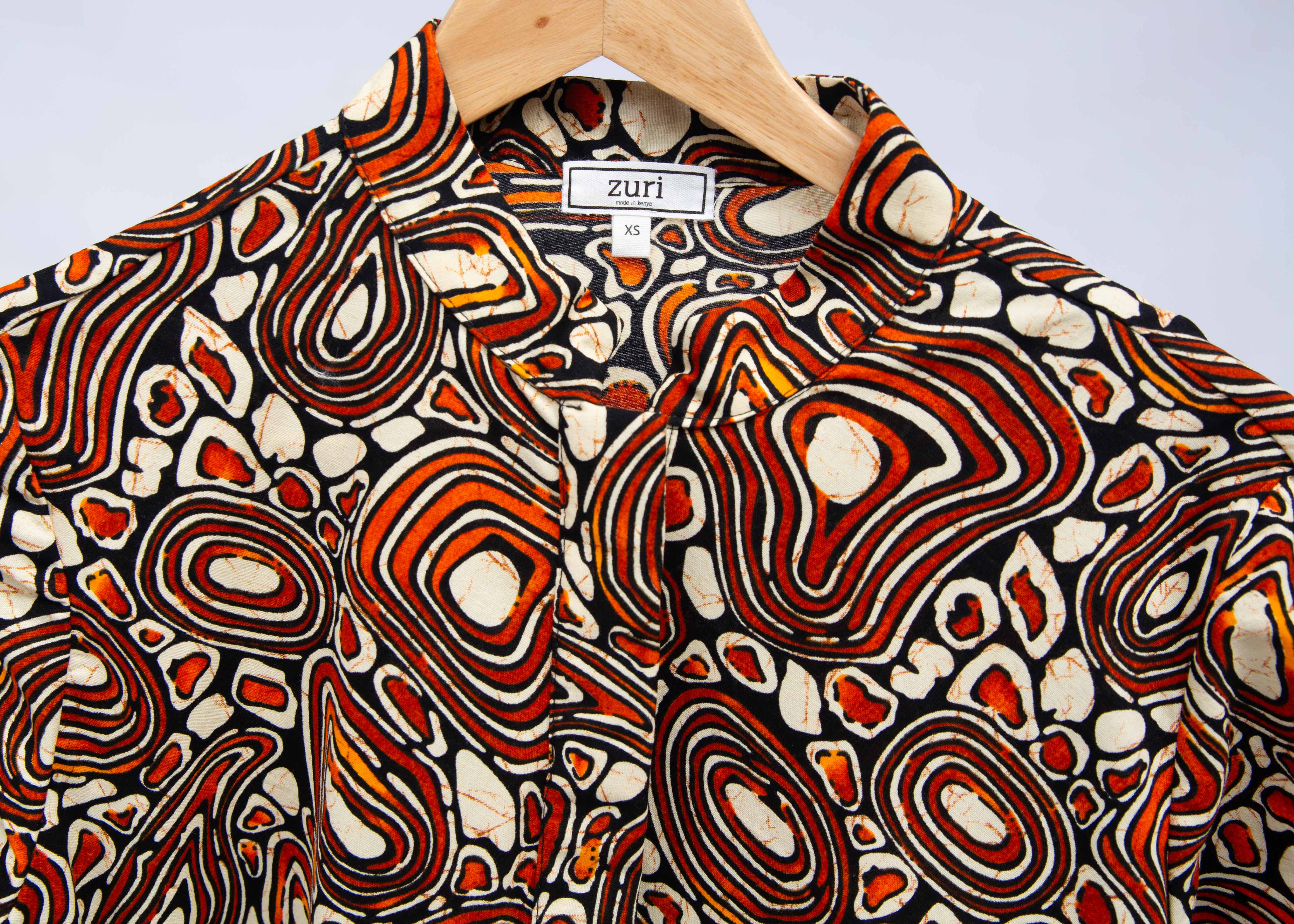 Display of brown, black and white pebble print dress.