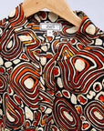 Display of brown, black and white pebble print dress.