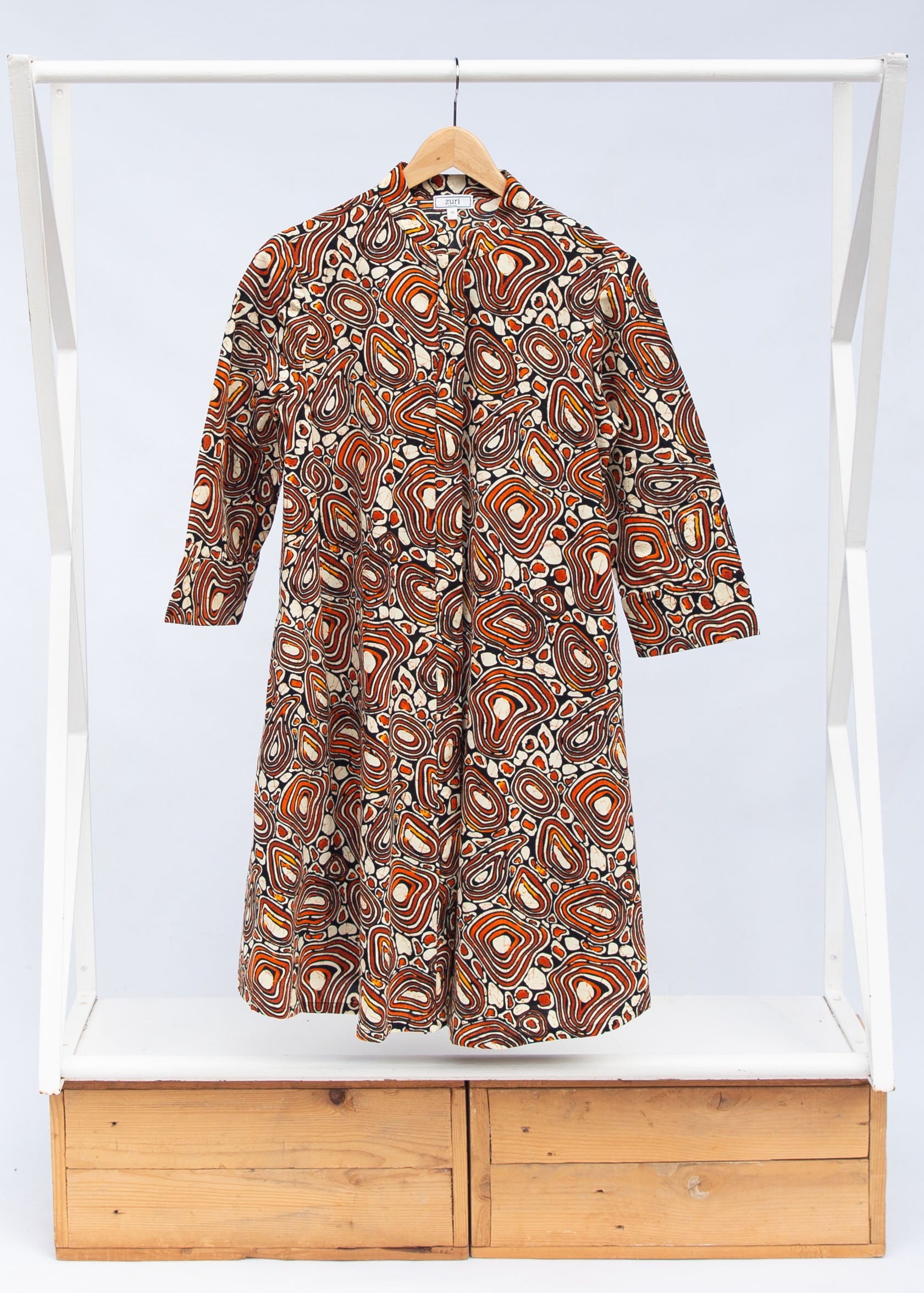 Display of brown, black and white pebble print dress.