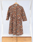 Display of brown, black and white pebble print dress.