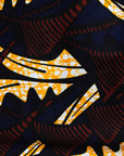 Display of long sleeve blouse with brown and yellow abstract print, fabric.