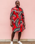 Model wearing red dress with black and white feather print.