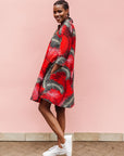 Model wearing red dress with black and white feather print.