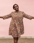 Model wearing brown, black and white pebble print dress.