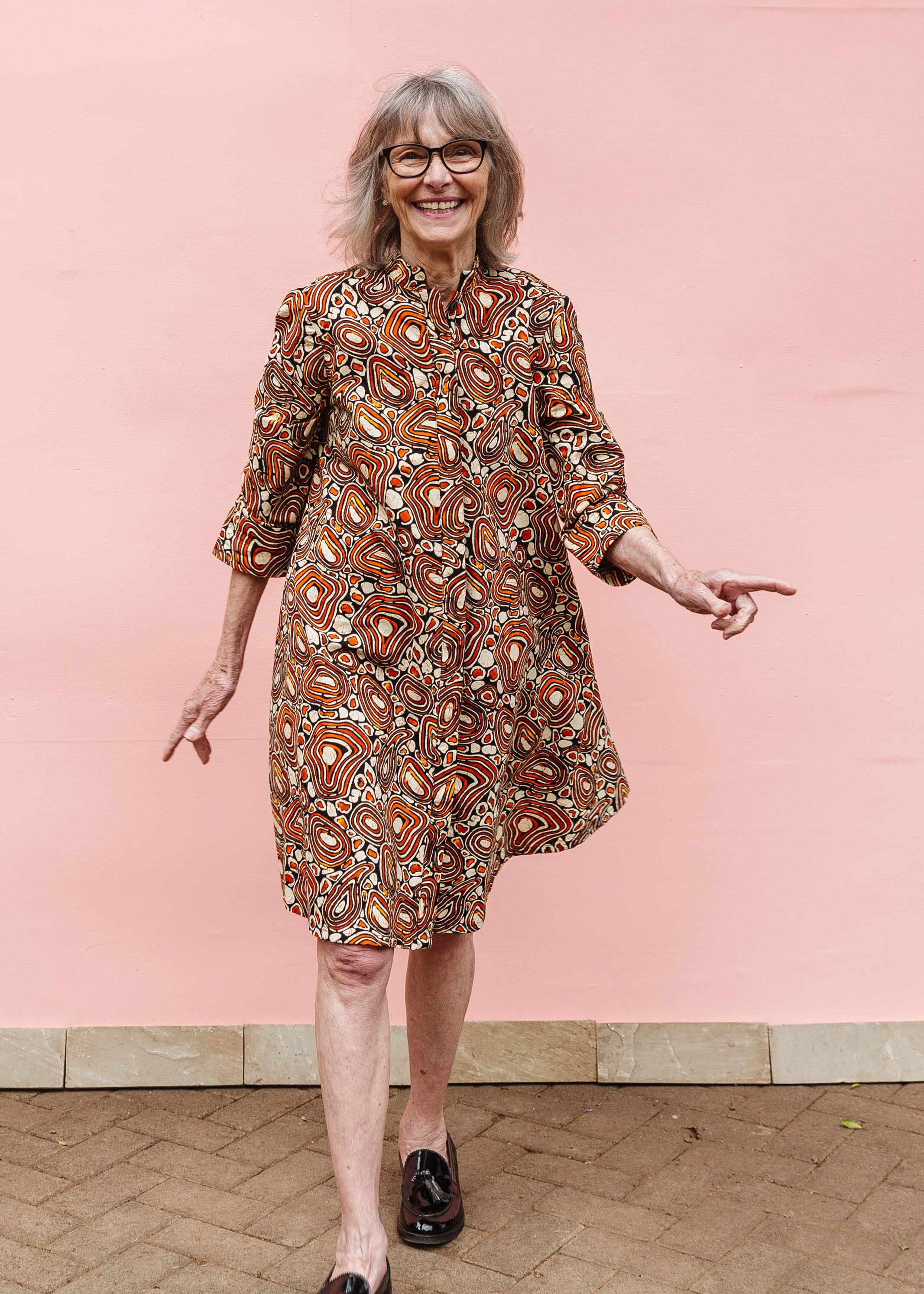 Model wearing brown, black and white pebble print dress.