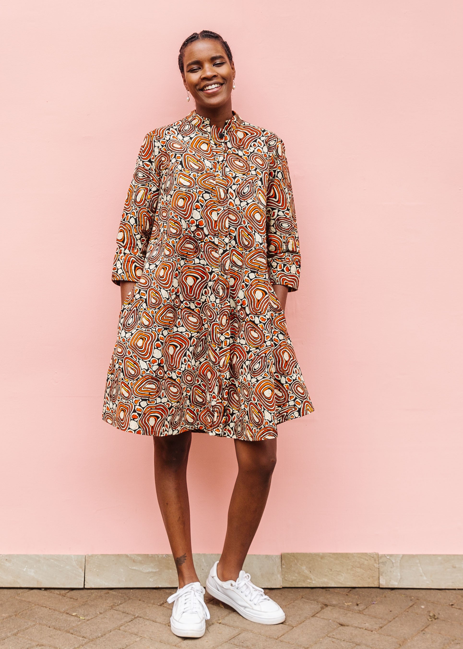 Model wearing brown, black and white pebble print dress.