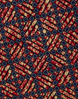 Close up display of red, navy and white mosaic print dress, fabric.