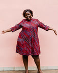 model wearing a red ladder design dress