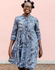 model wearing a black and white palm tree design dress