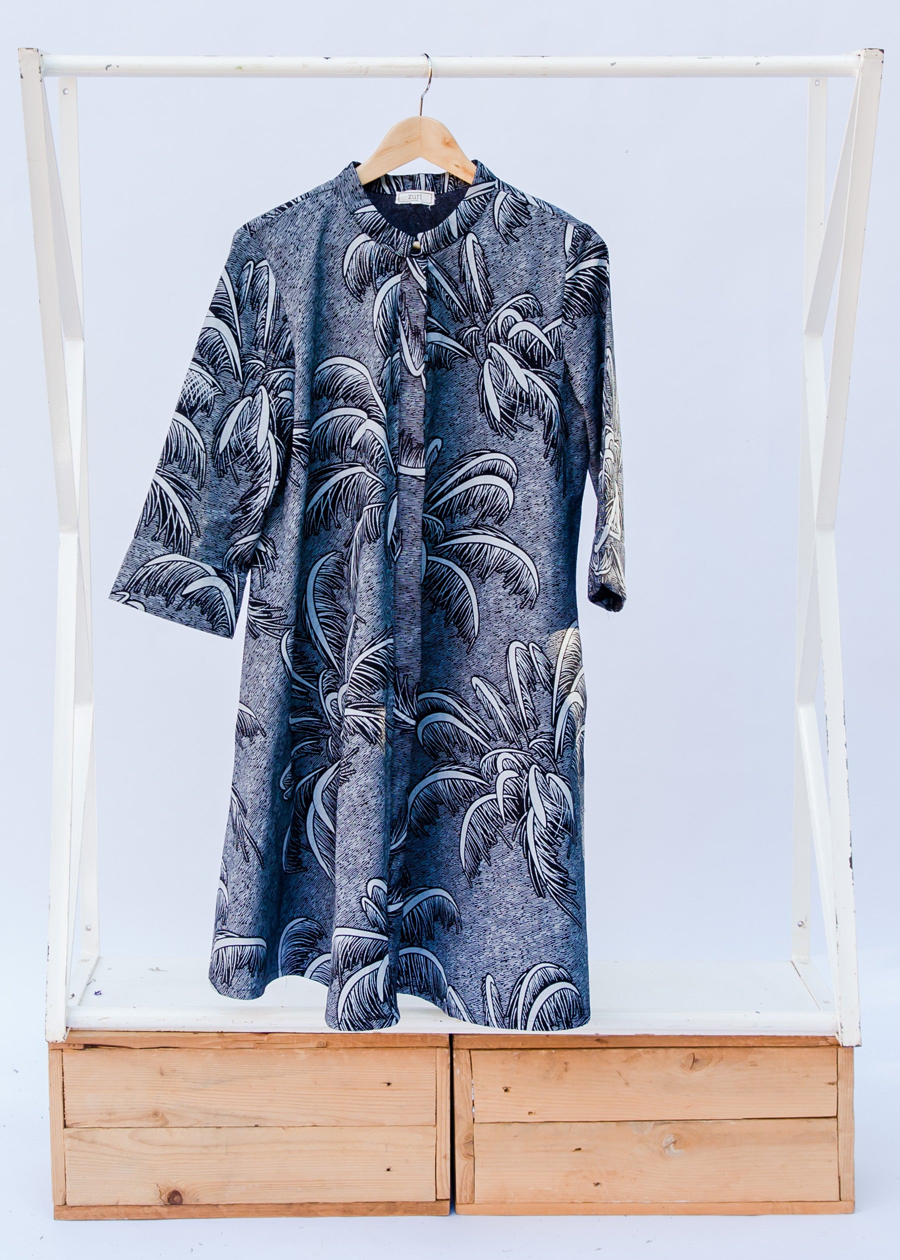 Display of a black and white palm tree design dress