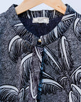 Display of a black and white palm tree design dress