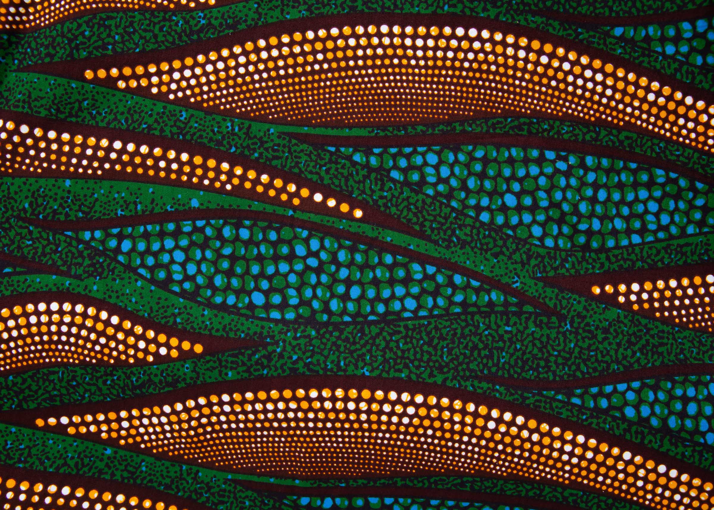 Close up display of blue, green and orange abstract line dress, fabric.