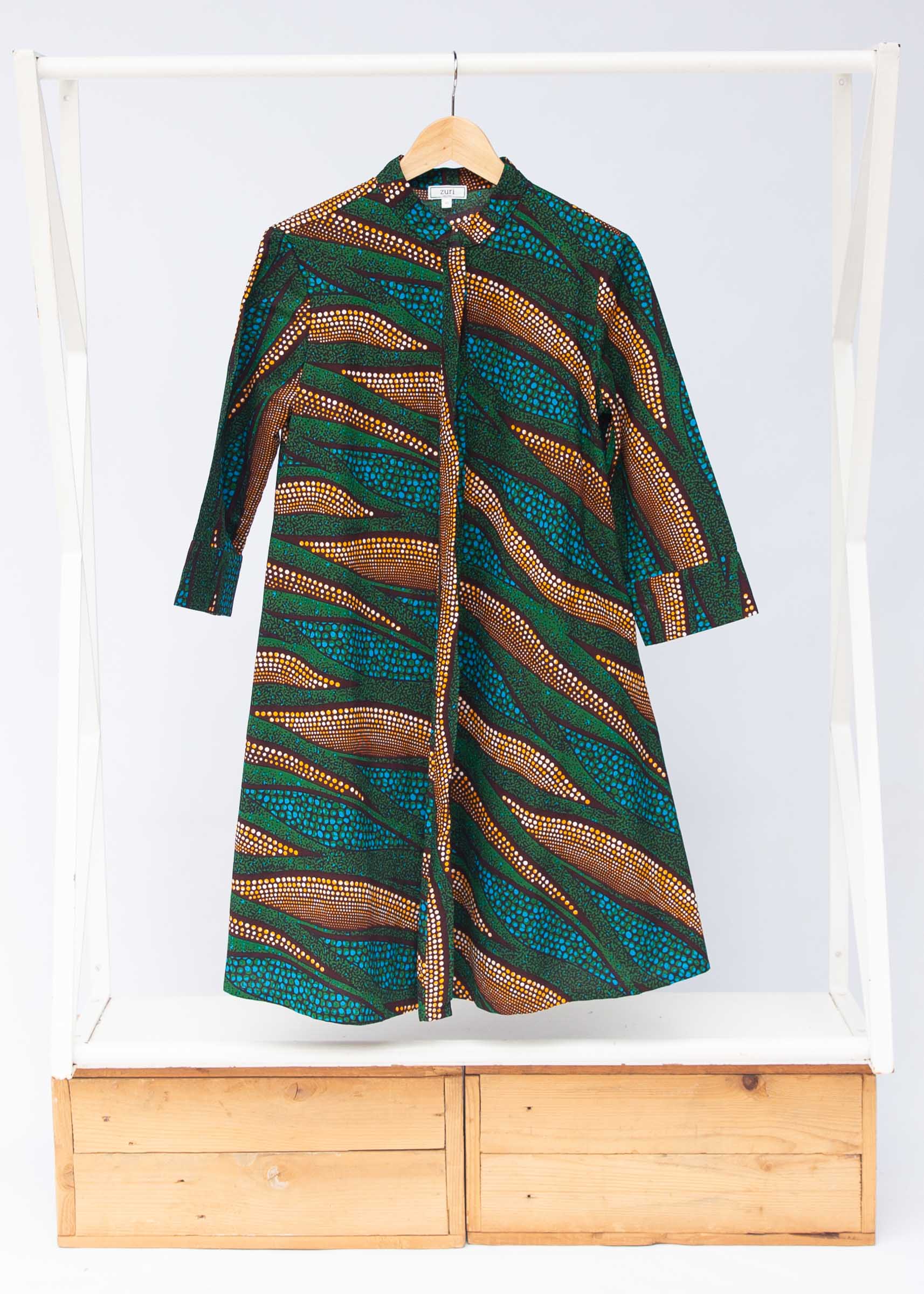 Display of blue, green and orange abstract line dress.