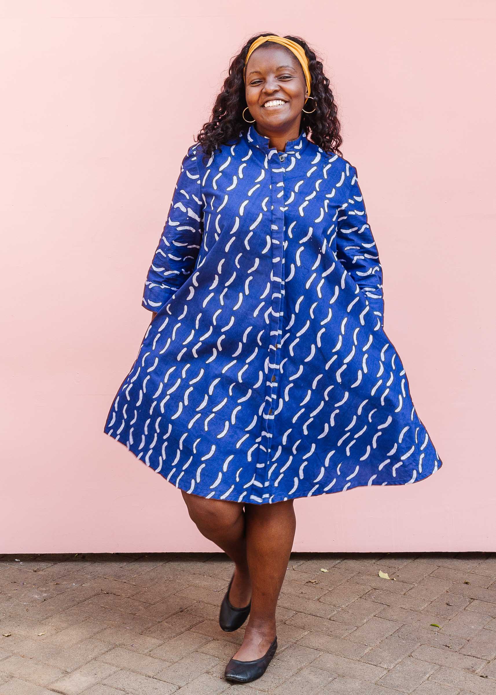 The model is wearing blue and white batik dress.