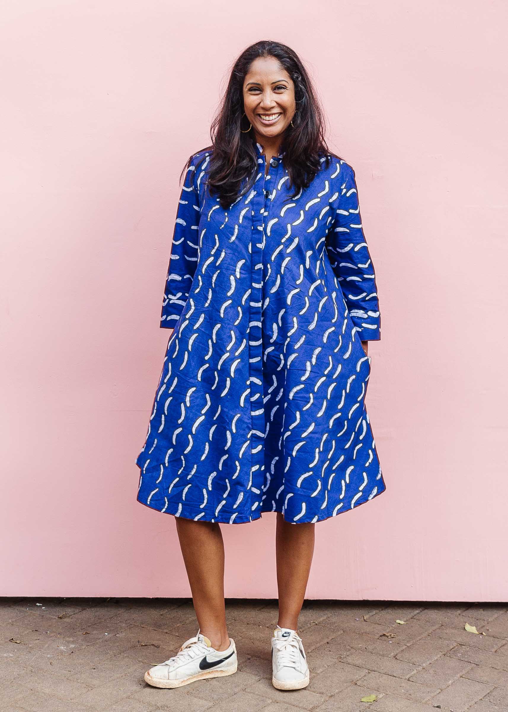 The model is wearing blue and white batik dress.
