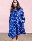 The model is wearing blue and white batik dress.