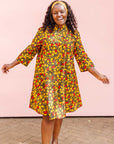 The model is wearing black dress with yellow and red small blob print.