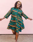 The model is wearing blue, green and orange abstract line dress.
