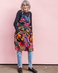 Model wearing patchwork apron.