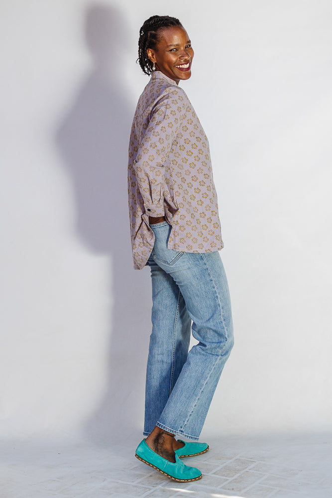 Model wearing linen top with small flower print.