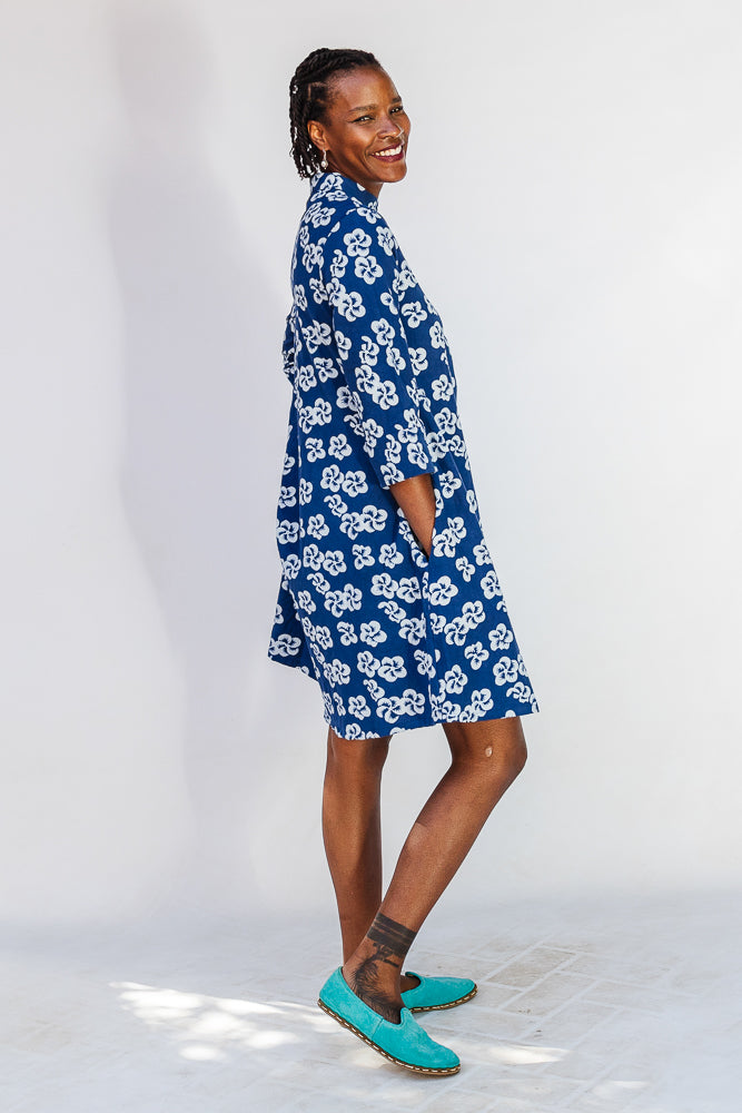 Model wearing blue and white floral dress.