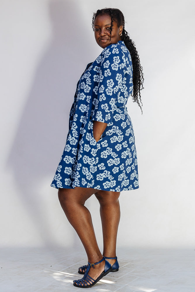 Model wearing blue and white floral dress.