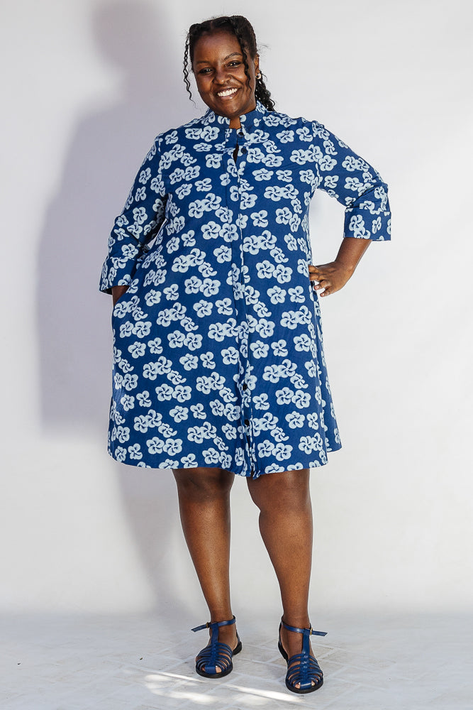 Model wearing blue and white floral dress.