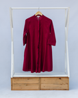 Display of burgundy linen dress.