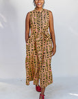 Model wearing beige, yellow and black geometric print dress.