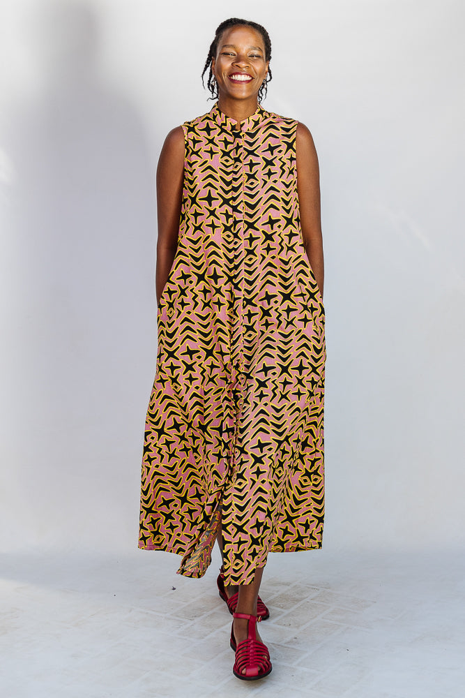 Model wearing beige, yellow and black geometric print dress.