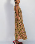 Model wearing beige, yellow and black geometric print dress.