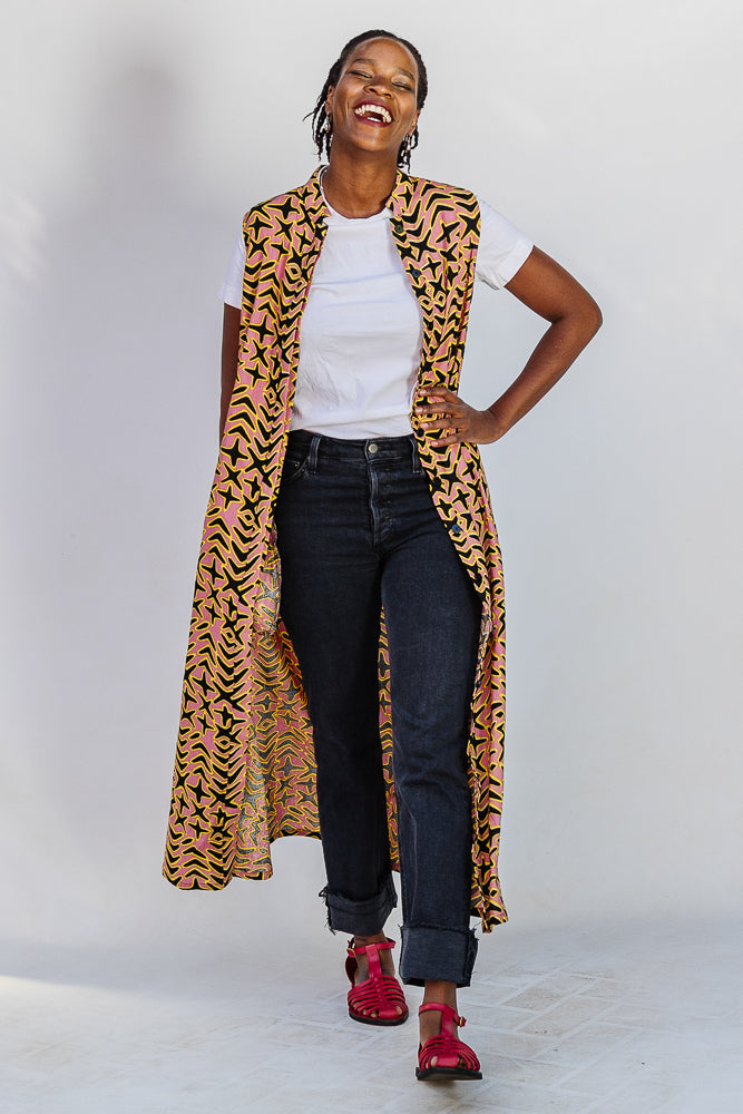 Model wearing beige, yellow and black geometric print dress.