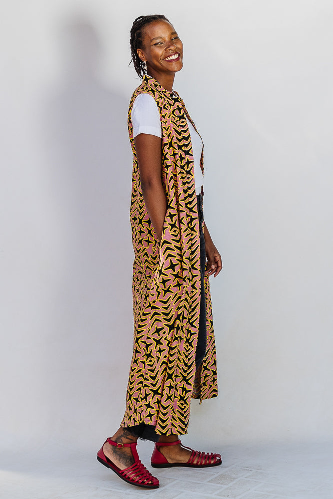Model wearing beige, yellow and black geometric print dress.
