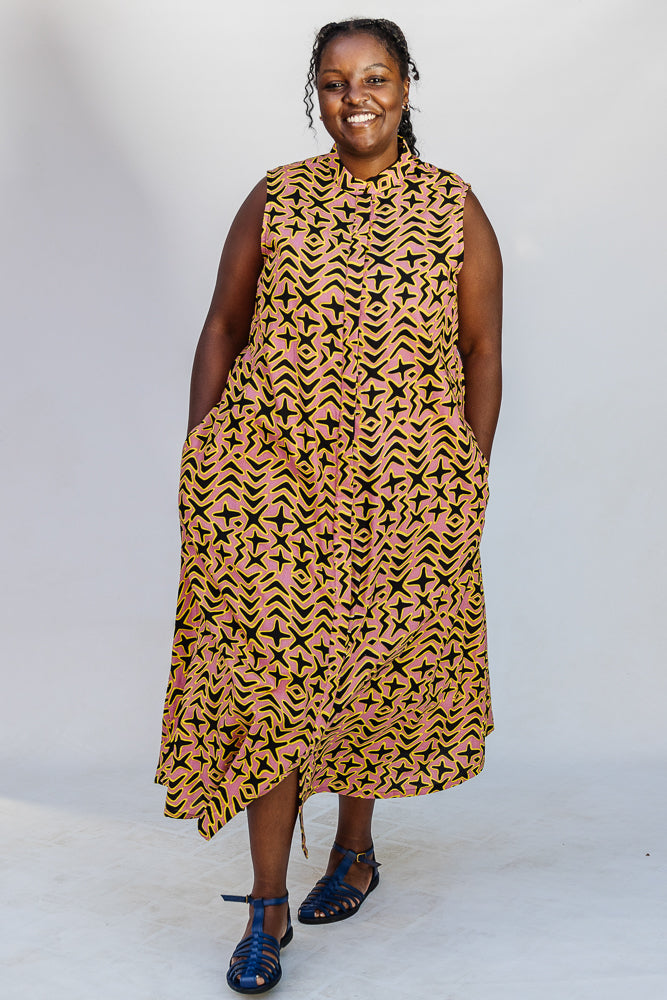 Model wearing beige, yellow and black geometric print dress.