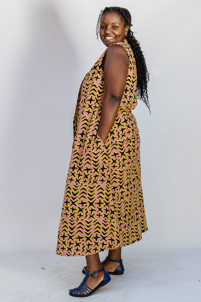 Model wearing beige, yellow and black geometric print dress.