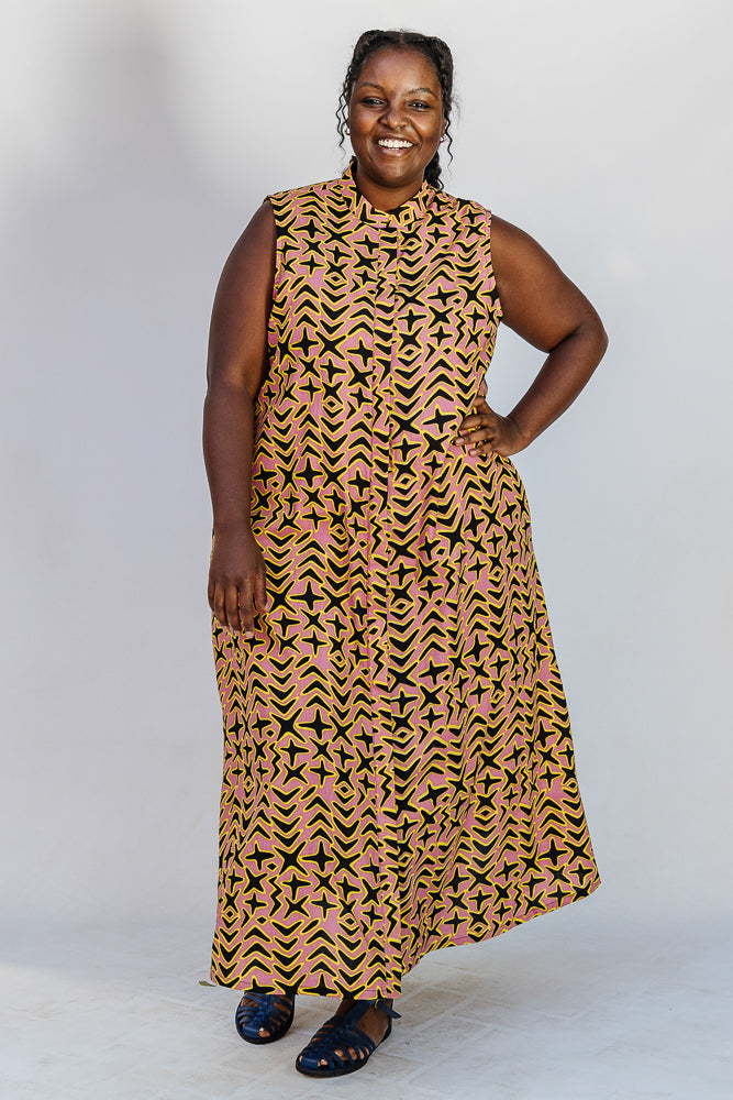 Model wearing beige, yellow and black geometric print dress.