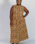 Model wearing beige, yellow and black geometric print dress.