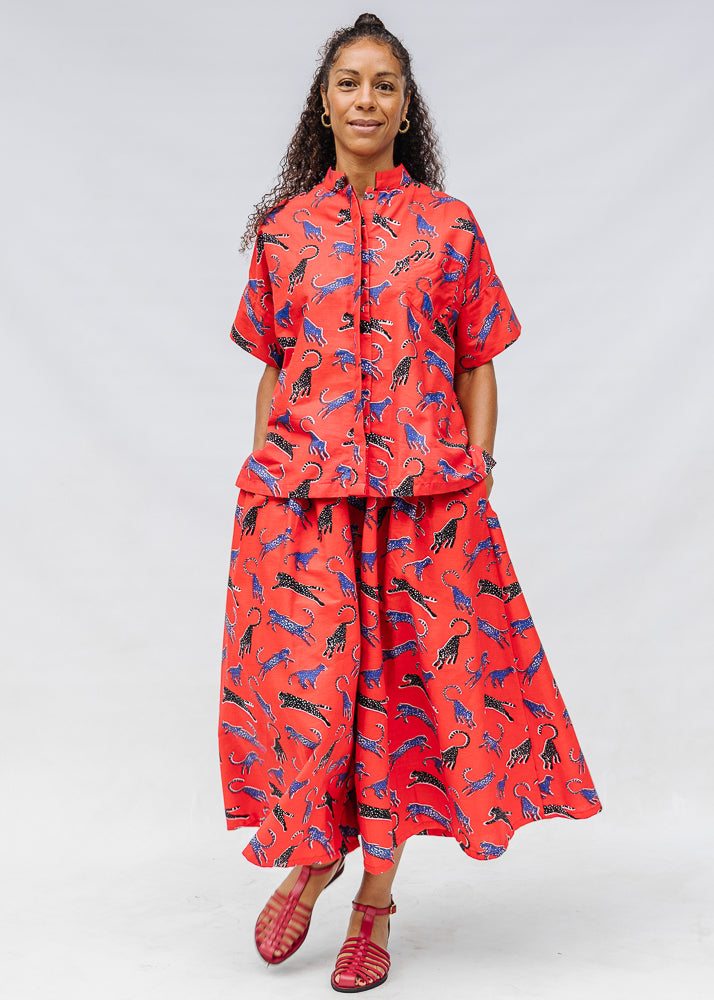 Model wearing red cat print shirt and culotte.