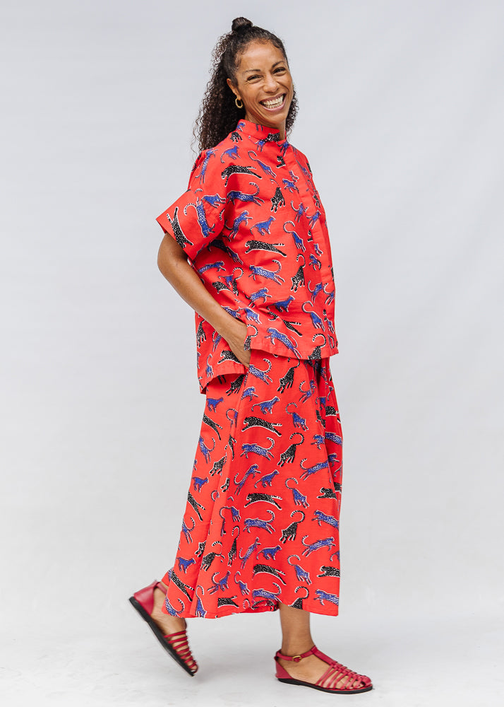 Model wearing red cat print shirt and culotte.