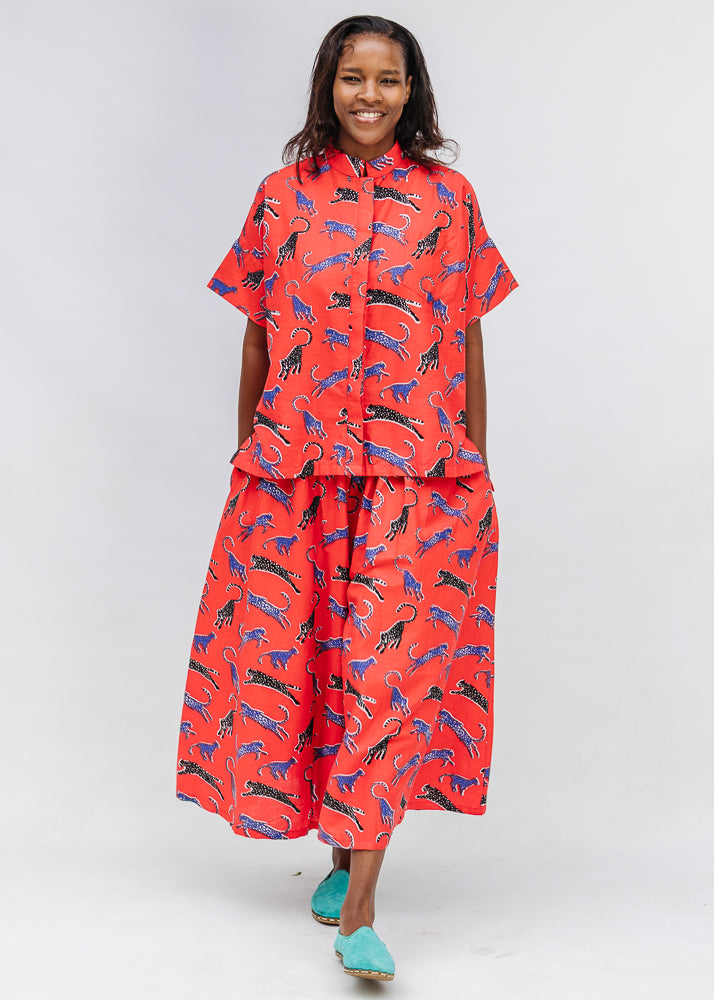 Model wearing red cat print shirt and culotte.