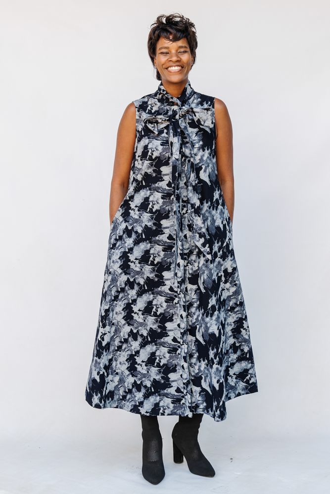 Model wearing navy and gray abstract print maxi dress.