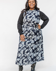 Model wearing navy and gray abstract print maxi dress.