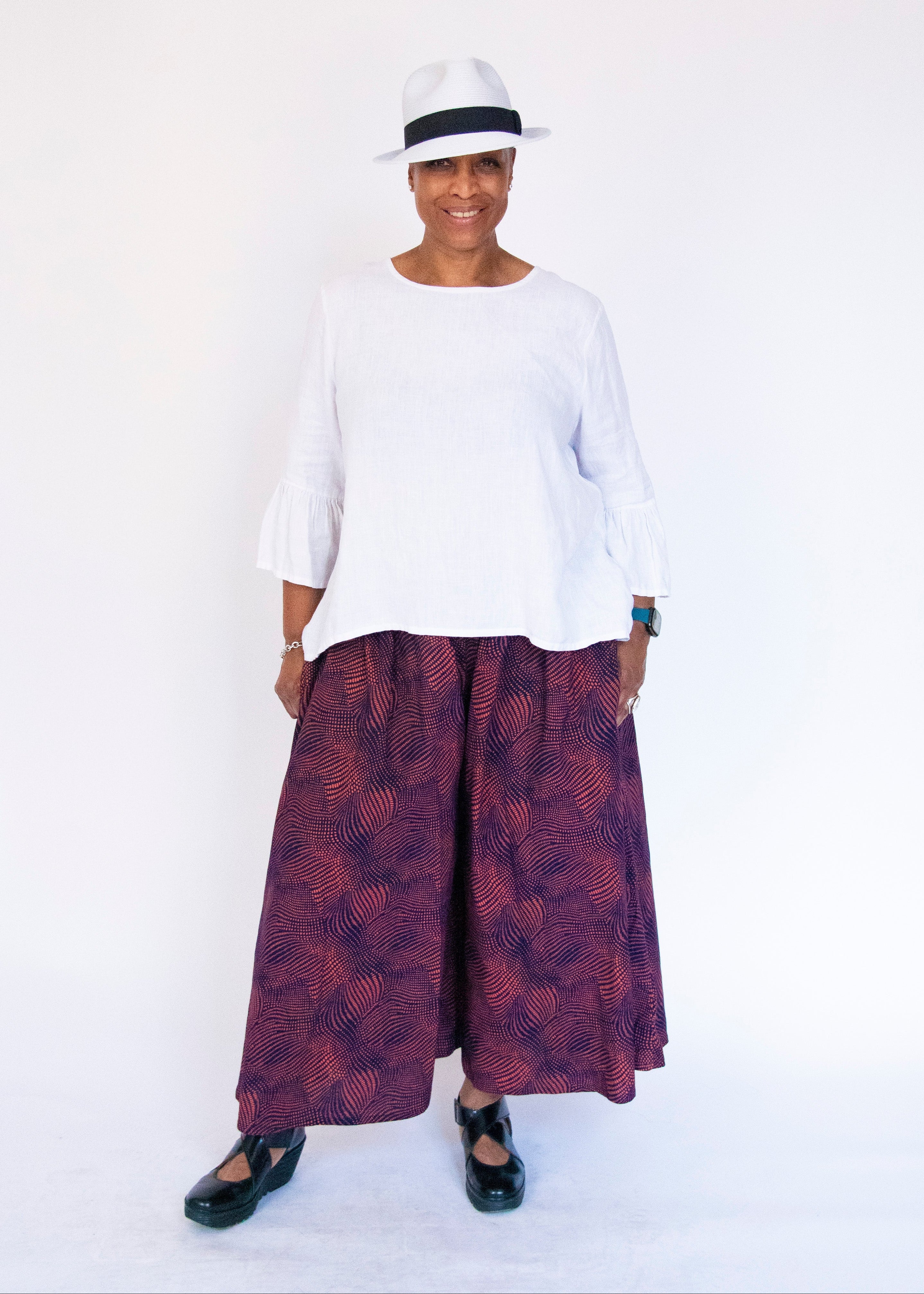Model wearing navy pants with pink dots.