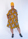 Model wearing orange and purple dress.