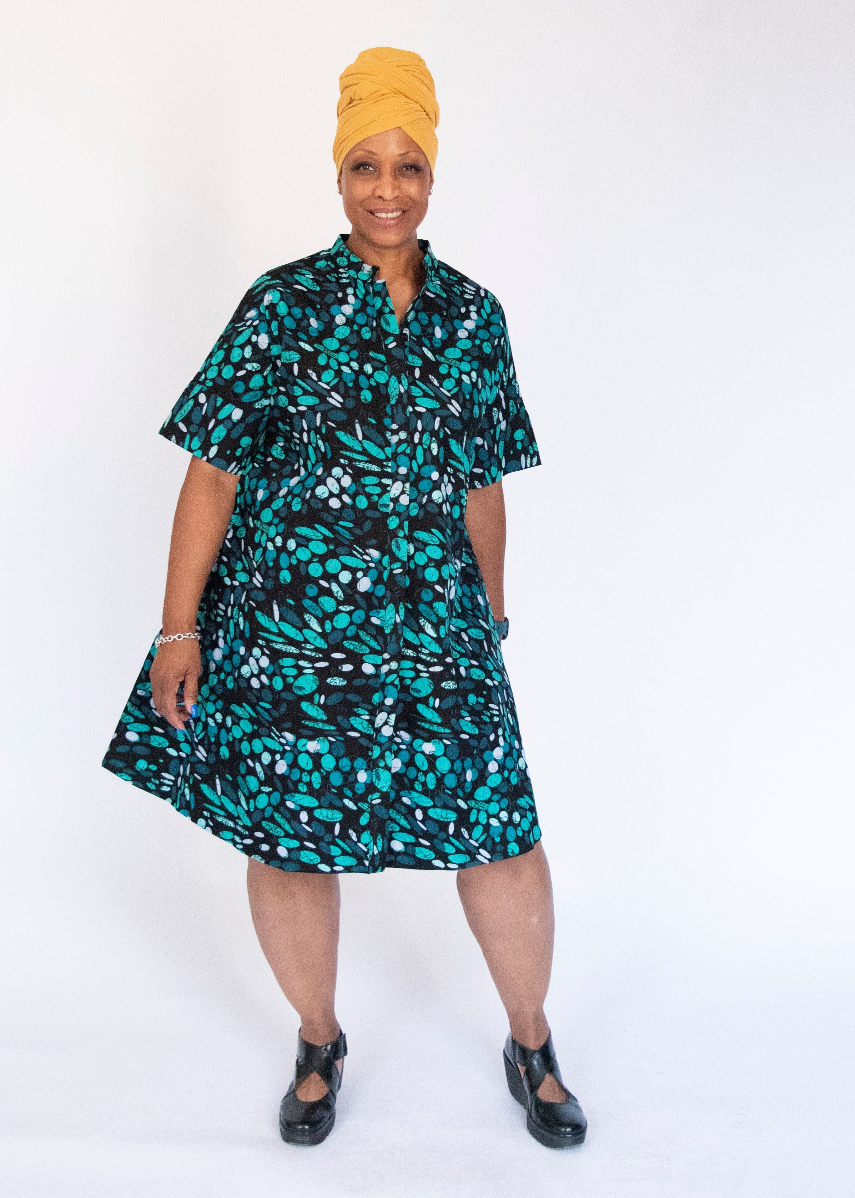Model wearing abstract blue pebble print dress.